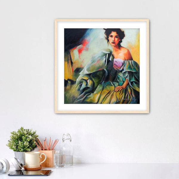 Framed painting of a woman in a green dress on a white wall with decor items below.
