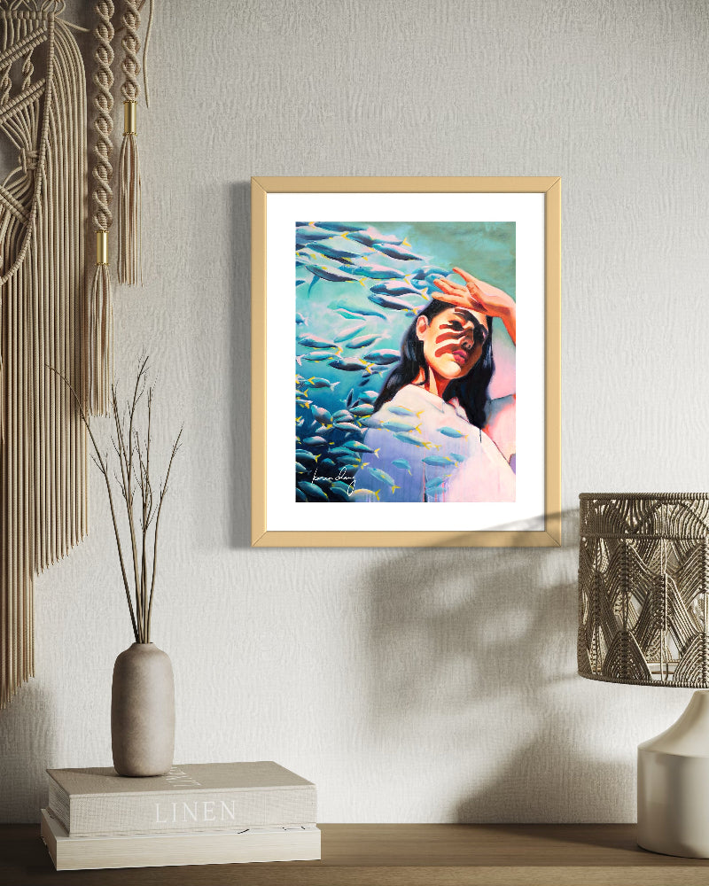 Framed artwork of a woman underwater with fish in a modern interior setting.