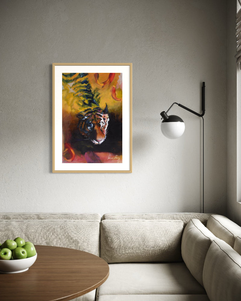 Framed painting of a tiger on a wall above a sofa in a living room.