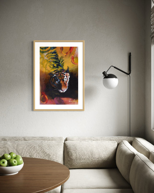 Framed painting of a tiger on a wall above a sofa in a living room.