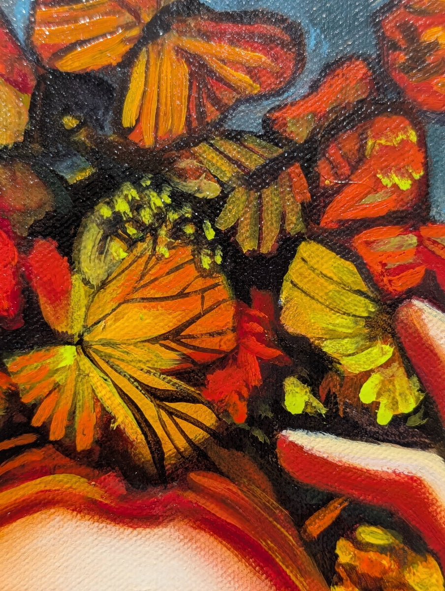 Close-up of a colorful butterfly illustration with vibrant orange, yellow, and red hues.