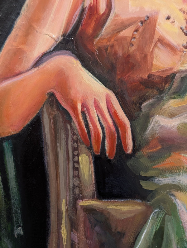 Close-up of a hand on an armchair with warm color palette