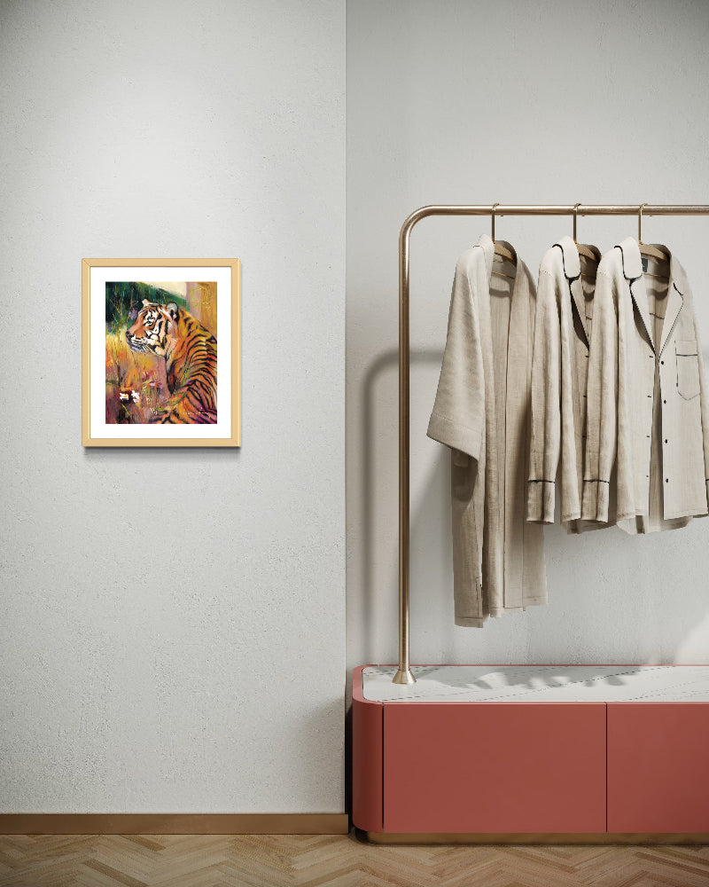Framed tiger painting on a wall next to a clothing rack with shirts and a red cabinet.