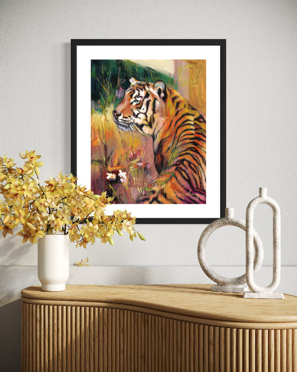 Framed painting of a tiger on a wall above a wooden console table with decorative items.