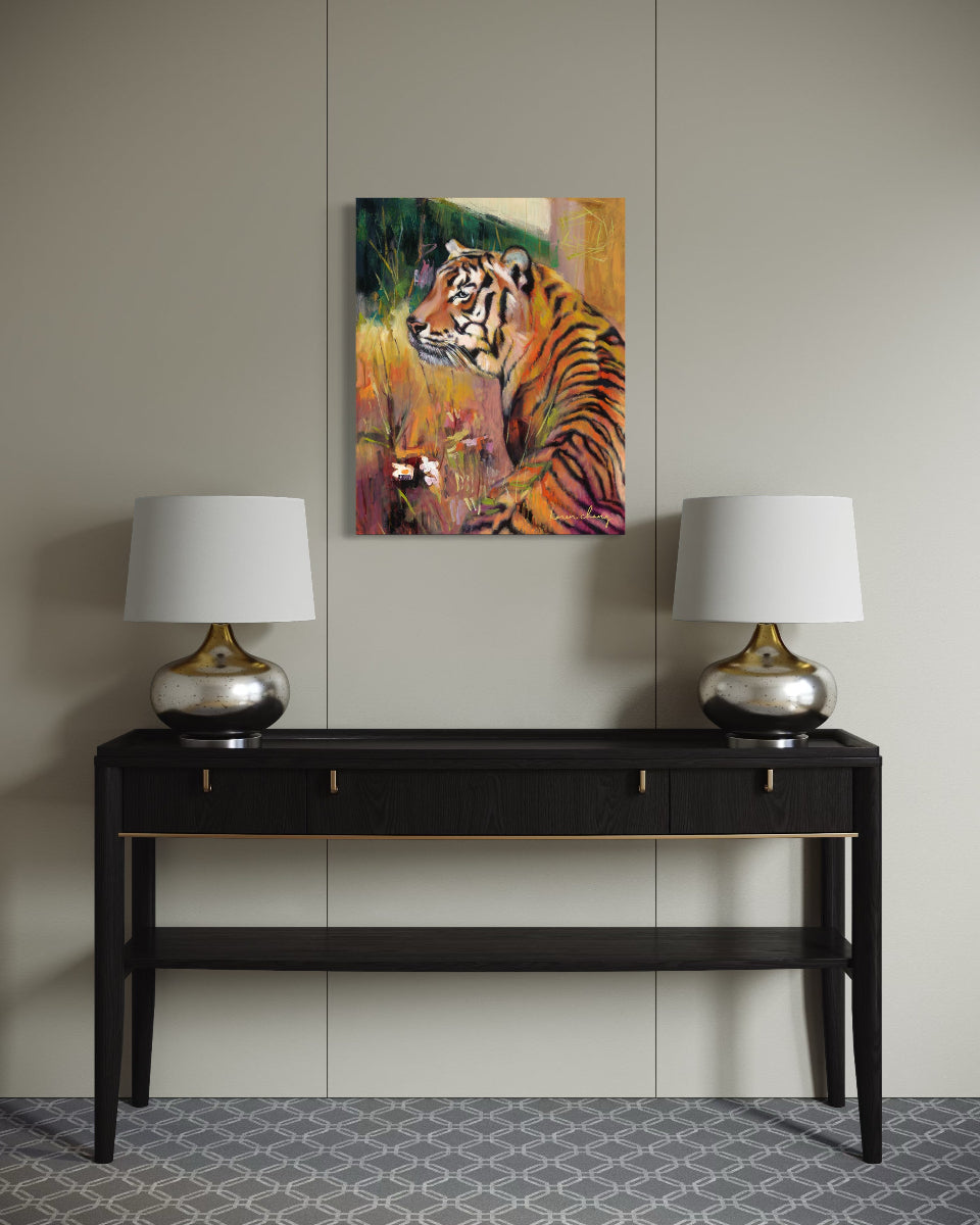 Decorative console table with two lamps and a tiger painting on a wall.