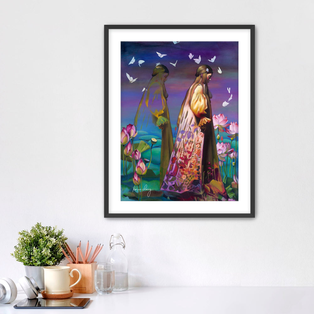 Framed artwork of two people in a garden with butterflies on a white wall.