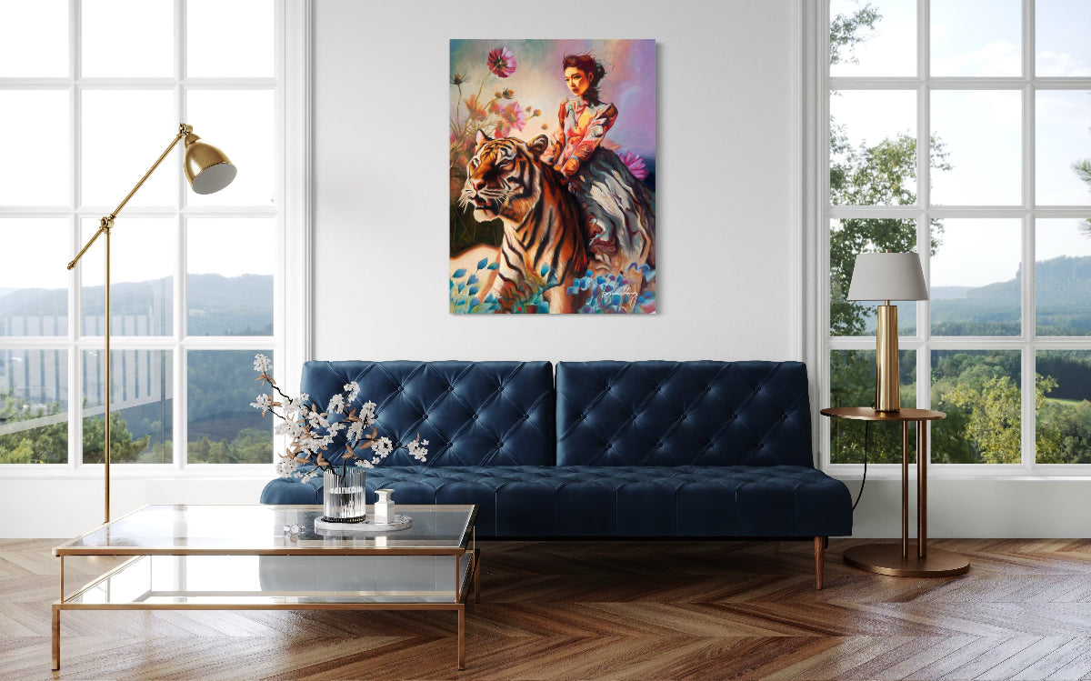 Modern living room with a blue sofa, artwork of a woman on a tiger, and large windows.