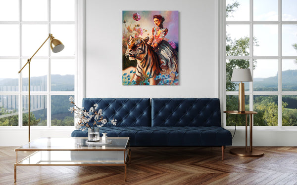 Modern living room with a blue sofa, artwork of a woman on a tiger, and large windows.
