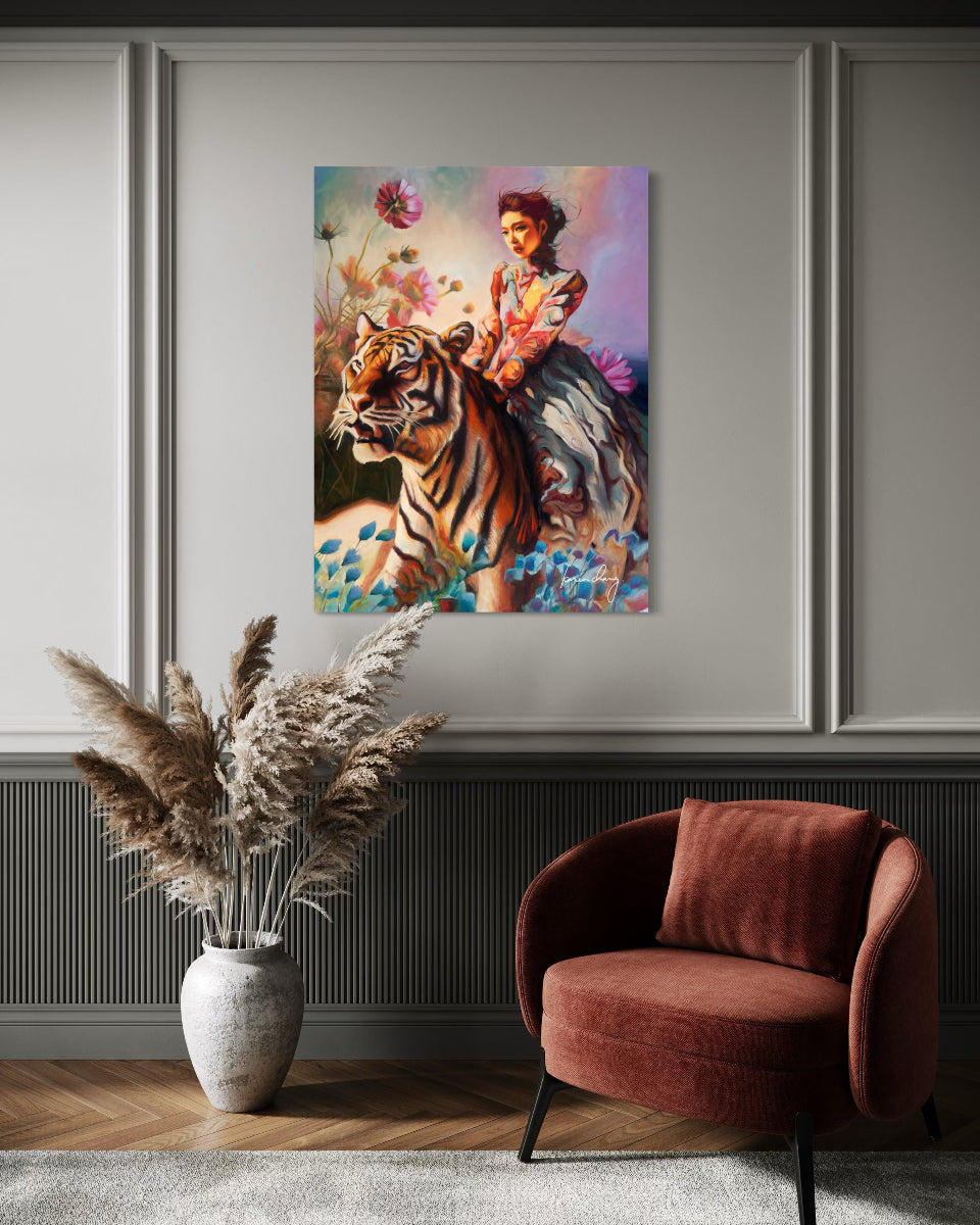 Framed artwork of a woman riding a tiger on a wall above a chair and vase.