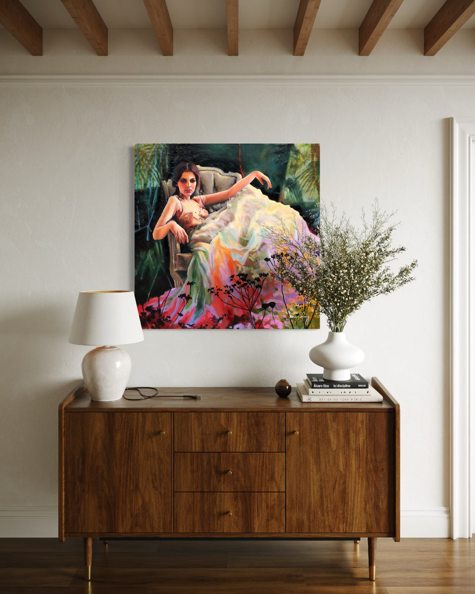 Wooden sideboard with a lamp, vase, and decorative items against a wall with a colorful painting.