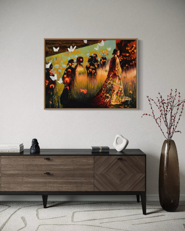 Framed artwork on a wall above a wooden console table with decorative items.