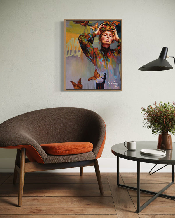 Modern living room with a brown and orange chair, round coffee table, and colorful wall art.